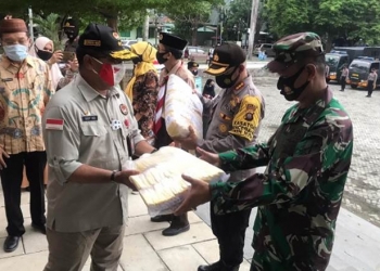 Deputi Bidang Koordinator Pemerataan Pembangunan Wilayah dan Penanggulangan Bencana Kementrian PMK, Mayjen (Purn) Dody Usodo saat menyerahkan masker gratis kepada TNI/Polri untuk selanjutnya di bagi bagikan kepada masyarakat di Provinsi Gorontalo, Jumat (25/9/2020). (Foto : Roman)