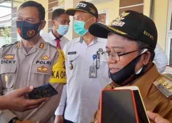 Bupati Gorontalo Utara, Indra Yasin saat diwawancarai oleh sejumlah media pada kegiatan pemusnahan miras jenis cap tikus, di Polres Gorontalo Utara.(foto.isno/gopos)