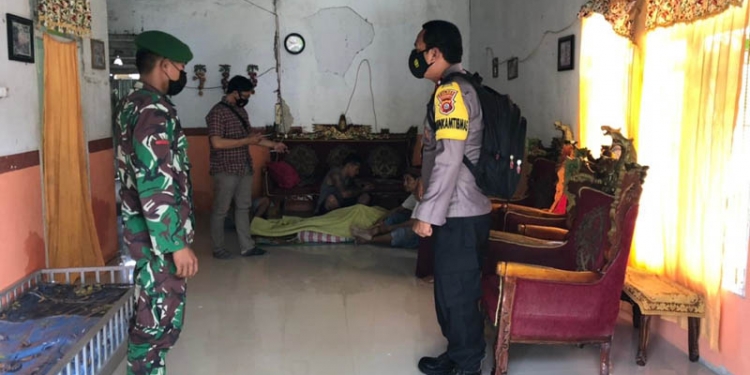 PEMERIKSAAN - Petugas Babinsa dan Bhabinkatimbas melakukan pemeriksaan terkait kematian seorang pemuda di Tibawa, Isran Hadi, Selasa (2/2/2021). (isitmewa)