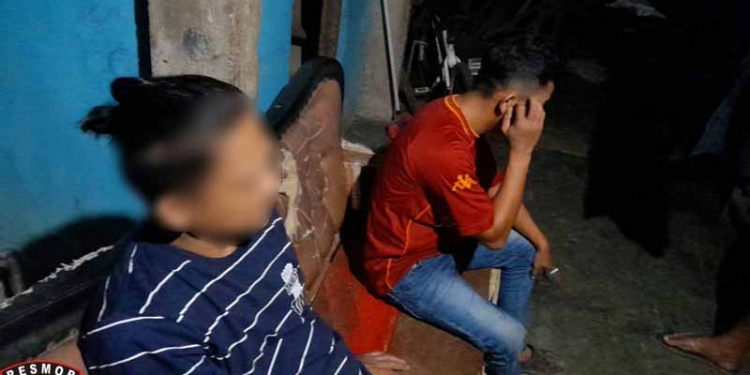 JUDI TOGEL - Terduga pelaku judi togel, RZK (kaos biru) saat dibekuk tim Resmob Polres Bone Bolango. (istimewa)
