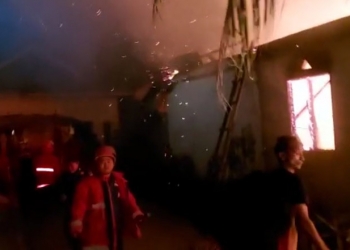 KEBAKARAN - Petugas pemadam kebakaran berupaya memadamkan kebakaran yang melanda dua rumah di Kelurahan Libuo, Kecamatan Dungingi, Kota Gorontalo. (istimewa)