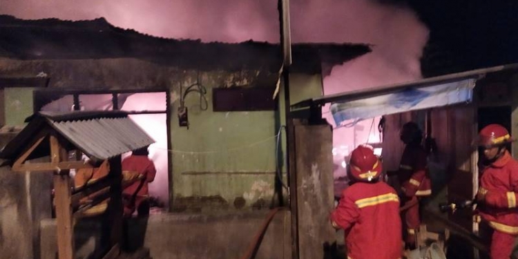 KEBAKARAN - Tim pemadam kebaran sementara melakukan pemadaman dua rumah yang terbakar di Jl. Eks Andalas, Kota Gorontalo, Jumat dini hari (12/2/2021) (istimewa)