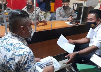 Hamzah Sidik menyampaikan laporan ke Polda Gorontalo, Selasa (23/3/2021).