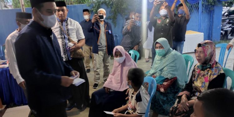 Ketua DPW Nasdem Gorontalo Hamim Pou saat memberikan santunan kepada para anak yatim piatu pada kegiatan buka bersama di DPD Nasdem Bone Bolango (foto istimewa)