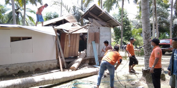 Petugas BPBD Pohuwato membersihkan material batang pohon yang menimpa rumah warga di di Dusun Liyono, Desa Pepaya, Kecamatan Dengilo, Kabupaten Pohuwato