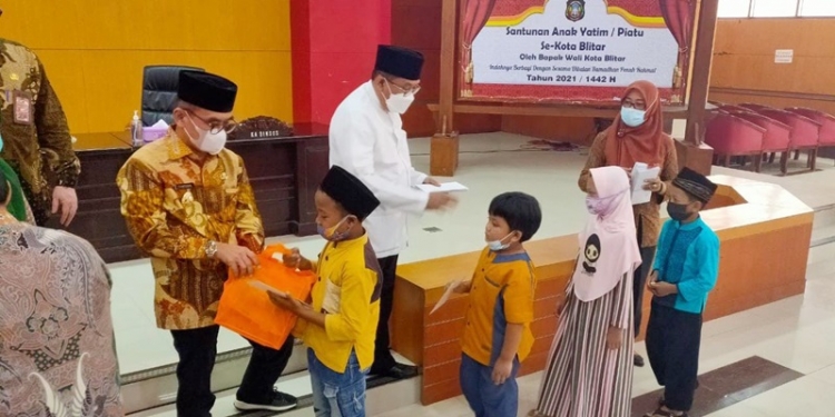 Wali Kota Blitar, Santoso saat menyerahkan santunan kepada anak yatim piatu, di Balai Kusumo wicitro, Jum'at (23/4/2021). (foto : ma'ruf/gopos)