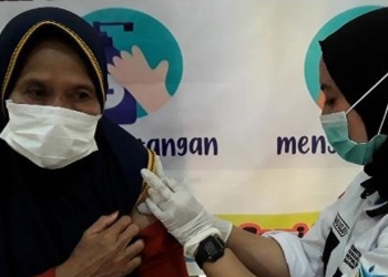 Petugas Kesehatan di Puskesmas Paguat, Pohuwato, saat melakukan vaksinasi terhadap lansia, Selasa (1/6/2021). (foto/istimewa).