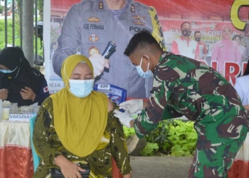 Vaksinasi Covid-19 kepada salah seorang warga di Puskesmas Tibawa, Kecamatan Tibawa, Kabupaten Gorontalo. (Foto: Putra/Gopos)