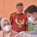 Bupati Pohuwato (batik merah), Saipul Mbuinga, menyaksikan proses penyuntikan vaksin Covid-19 kepada warga di Desa Sipatana, Kecamatan Buntulia, Kabupaten Pohuwato, Jumat (13/8/2021).