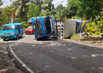 Truk kontainer bermuatan santan cair terbalik di turunan Pontolo Desa Pontolo, Kecamatan Kwandang, Gorontalo Utara, Kamis (12/8/2021). (isno/gopos)