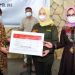Mensos Risma (kiri) menyerahkan bantuan ATENSI kepada Anggota Komisi VIII DPR RI, Idah Syahidah Rusli Habibie (tengah), di Angelato Resto & Cafe, Kota Gorontalo, Kamis (30/9/2021). (Foto: Haris)