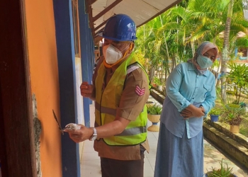 Bupati Bone Bolango, Hamim Pou didampingi Kepala Dinas Pendidikan dan Kebudayaan Marni Nisabu saat menghadiri peletakan batu pertama pembangunan rehabilitasi sembilan ruang kelas, ruang tata usaha, dan jamban SMP Negeri 2 Suwawa. (Foto Indra/Gopos)