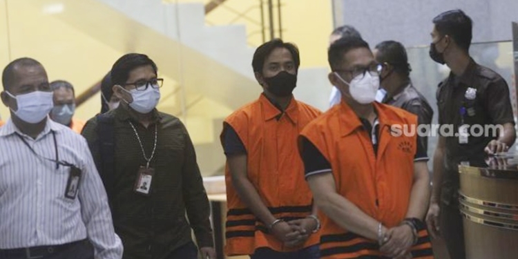 Bupati Penajam Paser Utara Abdul Gafur Mas'ud (kedua kanan) berjalan menuju ruang konferensi pers usai menjalani pemeriksaan terkait operasi tangkap tangan (OTT) di Gedung Merah Putih KPK, Jakarta, Kamis (13/1/2021) malam. [Suara.com]