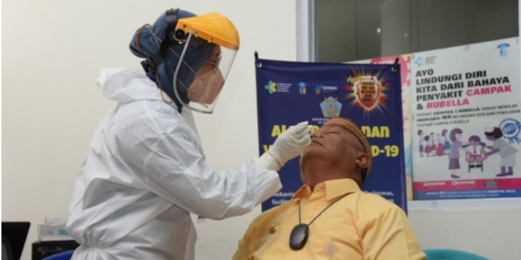 Gubernur Gorontalo Rusli Habibie saat melakukan PCR bersama-sama dengan petugas di Bandara udara Gorontalo, kamis (6/1/2022) . Foto – Salman