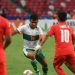 Asnawi Mangkualam Bahar (kedua dari kiri) mencoba melewati pemain Singapura Faris Ramli (kedua dari kanan) dan Zulfahmi Arifin (kanan) pada leg pertama semifinal Piala AFF 2020 antara Singapura dan Indonesia di Stadion Nasional di Singapura pada 22 Desember 2021. Roslan RAHMAN / AFP
