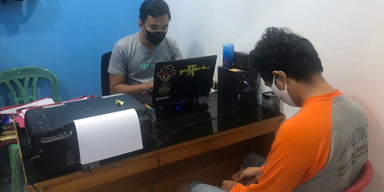 Petugas Polsek Kota Timur memeriksa AHA terduga pelaku pencurian handphone. (Humas Polres Gorontalo Kota)
