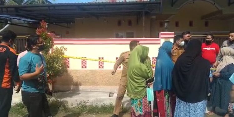 Sejumlah warga berkumpul di depan rumah ID, ASN Pohuwato yang ditemukan gantung diri, Selasa (1/3/2022). (Yusuf/gopos)