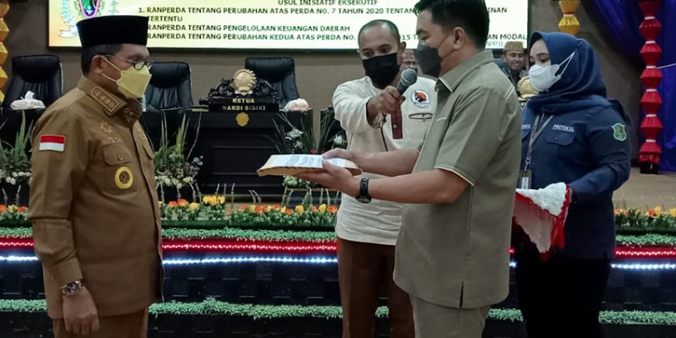 Ketua DPRD Kota Gorontalo Hardi Sidiki ketika menerima dokumen  atas 3 ranperda usul inisiatif eksekutif, yang diserahkan oleh walikota Gorontalo, Marten Taha.(foto Sari)