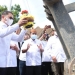 Pemecahan kendi di alat berat ekskavator oleh Pj Gubernur Gorontalo Hamka Hendra Noer saat mencanangkan pekerjaan kanal banjir Tanggidaa di Kecamatan Kota Timur, Kota Gorontalo, Rabu (18/5/2022). Foto – Salman