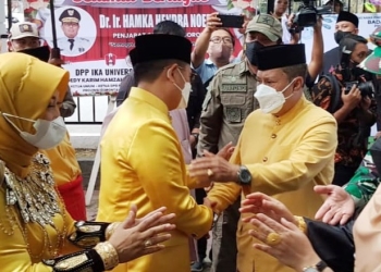 Ketua DPRD Provinsi Gorontalo, Paris RA Jusuf berjabatangan dengan PJ Gubenur Gorontalo, Hamka Hendra Noer saat mengikuti upacara adat Moloopu di Rumah Dinas Gubernur, Senin (16/5/2022).  (istimewa)