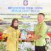 Kepala Bidang Informasi Komunikasi Publik (IKP) Diskominfotik Provinsi Gorontalo, Zakiya Baserewan (kiri), menyerahkan manual book Panduan Remaja Cakap Digital kepada Wakil Kepala Sekolah SMA 1 Marisa, I Nyoman Sarda, pada kegiatan Implementasi Recak Digital, di aula SMA 1 Marisa, Kamis (19/5/22). ( Foto: Alfred)