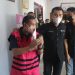 Kepala Dinas PUPR Pohuwato, AS, berjalan keluar dari ruang pemeriksaan Kejaksaan Tinggi Gorontalo, Jumat (17/6/2022). (istimewa)
