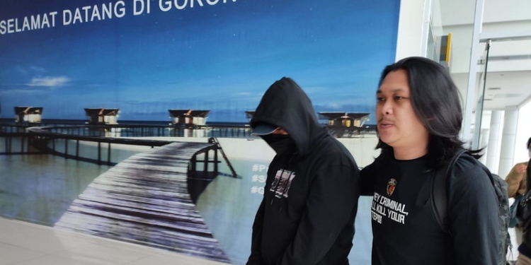 Dibawah pengawalan ketat Tim Ditreskrimum Polda Gorontalo Rahmat Is Ambo tiba di Gorontalo, Senin (29/8/2022). (Foto: Istimewa)