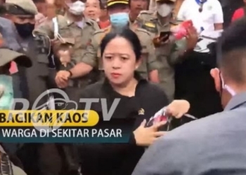 Puan Maharani bagikan kaos ke warga dengan wajah tegang. (suara.com)