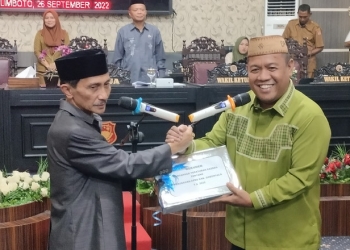 Bupati Gorontalo, Nelson Pomalingo saat menyerahkan nota pengantar RAPBD-P kepada Ketua DPRD Kabupaten Gorontalo, Syam T Ase. (Foto: Putra/Gopos)
