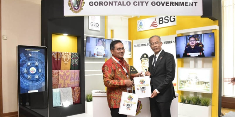 Wali Kota Gorontalo, Marten Taha, memberikan cinderamata kepada Wali Kota Kuala Lumpur pada ASEAN Forum Mayors di Surabaya, Jawa Timur. (Pemkot Gorontalo)