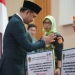 Wakil Wali Kota Gorontalo, Ryan Kono saat menyerahkan bantuan kepada keluarga perintis kemerdekaan di Kota Gorontalo. (Foto: Humas)
