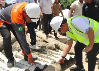 Penjagub Gorontalo, Hamka Hendra Noer (kanan), memeriksa aramco yang digunakan untuk saluran kanal banjir Tanggidaa, Sabtu (15/10/2022). (Foto : Haris)