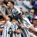 Gelandang Argentina Leandro Paredes melompati rekan satu timnya saat mereka selebrasi ketika pemain depan Argentina Lionel Messi mencetak gol saat pertandingan sepak bola perempat final Piala Dunia 2022 antara Belanda dan Argentina di Stadion Lusail, utara Doha, Qatar, Jumat (9/12/2022). [MANAN VATSYAYANA/AFP]