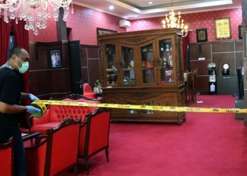 Petugas memasang garis polisi saat olah TKP di salah satu ruangan Rumah Dinas (Rumdin) Wali Kota Blitar, Jawa Timur, Senin (12/12/2022). ANTARA FOTO/Humas Polres Blitar Kota
