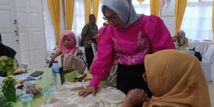 Ketua Dekranasda Provinsi Gorontalo saat menilai sulaman karawo para peserta bimtek peningkatan kreativitas dan daya saing sulaman karawo Gorontalo tahun 2022, Jumat (2/12/2022) bertempat di Aula Rujab Wakil Gubernur. (Foto – Fadly)