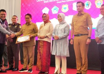 Direktur PT. Rumah UMKM Indonesia, Taufik Akbar, menyerahkan penghargaan kepada Penjagub Gorontalo, Hamka Hendra Noer, pada peluncuran toko daring BeliUMKM mitra LKPP di Grand Palace Convention Center, Kota Gorontalo, Selasa (7/2/2023). (Foto : Haris)