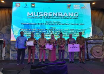 Wabup Merlan S. Uloli saat menerima dua penghargaan saat pelaksanaan Musyawarah Perencanaan Pembangunan ( Musrenbang) tingkat Provinsi Gorontalo di Ballroom Hotel Aston Gorontalo, Senin (10/4/2023). (Foto Aisiyah/Magang Diskominfo)
