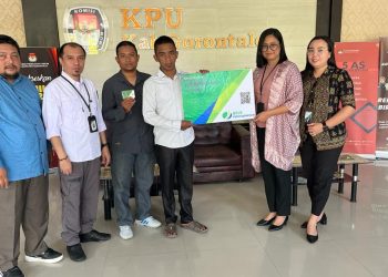 Kepala BPJS Ketenagakerjaan Cabang Gorontalo, Arif Budiman, yang diwakili Kepala Bidang Keuangan Natasha Angelica saat menyerahkan Ribuan kartu peserta BPJS Ketenagakerjaan yang terdiri dari 1.341 anggota Badan Ad Hoc KPU Kabupaten Gorontalo dan 826 anggota Badan Ad Hoc Kabupaten Gorontalo Utara