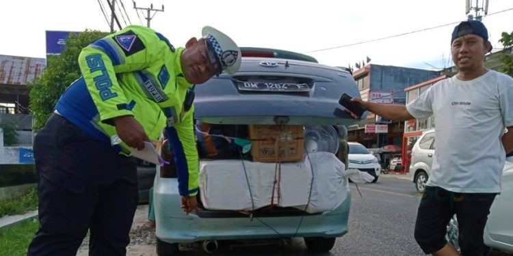 Seorang anggota Polantas Polda Gorontalo mendapati salah satu mobil yang menggunakan knalpot brong. (F polda)