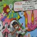 Dua anak berjalan melintasi mural Pemilu 2024 di Pandeglang, Banten, Senin (6/3/2023). Mural tersebut bertujuan untuk mengajak warga berpartisipasi dalam menyukseskan Pemilu 2024 serta menolak politik uang. (ANTARA FOTO/Muhammad Bagus Khoirunas/rwa.)