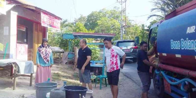 Ketua DPRD Bone Bolango, Halid Tangahu saat mengawal pendistribusian air bersih ke masyarakat, Ahad (15/10/2023).