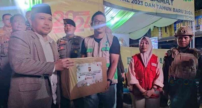 Penjagub Gorontalo Ismail Pakaya menyerahkan bingkisan kepada petugas pos pengamanan yang telah bersiaga selama Nataru, saat peninjauan posko pengamanan Natal dan Tahun Baru (Nataru), di Simpang Lima, Telaga, Kabupaten Gorontalo
