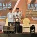 Pasangan calon Bupati dan Wakil Bupati Pohuwato Saipul Mbuinga dan Iwan Adam saat debat perdana, Minggu (27/10/2024).