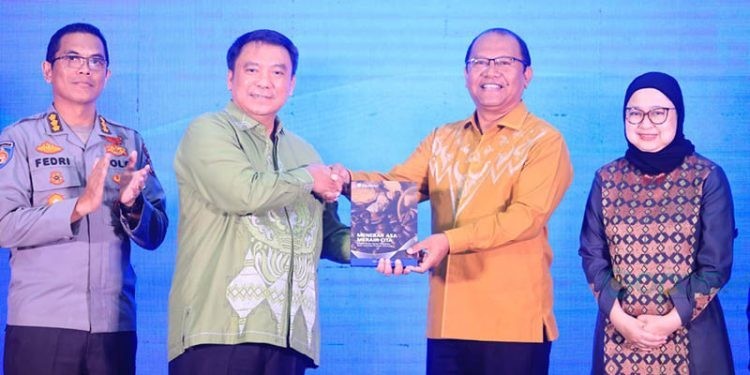 Kepala Perwakilan BI Provinsi Gorontalo, Dian Nugraha (kiri) menyerahkan buku UMKM kepada Sekretaris Daerah Provinsi Gorontalo, Sofyan Ibrahim (kanan). (Putra/Humas BI Gorontalo)