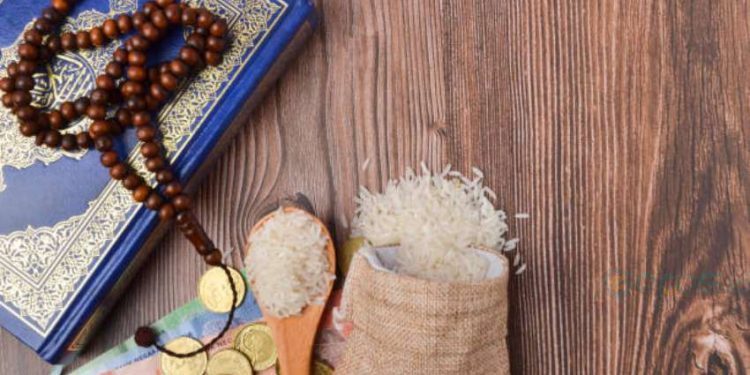 Coins, rosary, Holy Quran and rice in the sack. Zakat concept. Zakat is a form of alm-giving as a religious obligation or tax. Large Arab word right method to read correctly.