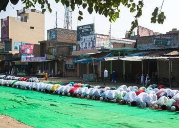 Baheri, Bareilly, Uttar Pradesh, India - September 25, 2015: Large group of people praying Namaz on Eil-al-adha, on the street.