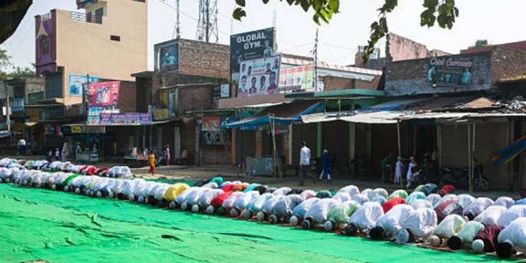 Baheri, Bareilly, Uttar Pradesh, India - September 25, 2015: Large group of people praying Namaz on Eil-al-adha, on the street.