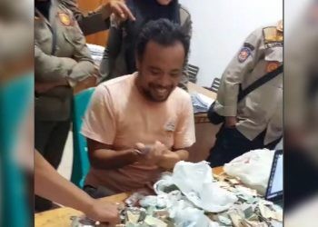 Lutfi, si Pengemis Kaya,menghitung uang yang dikumpulkan dari mengemis saat diamankan Satpol PP Kota Gorontalo, Kamis (3/7/2025)