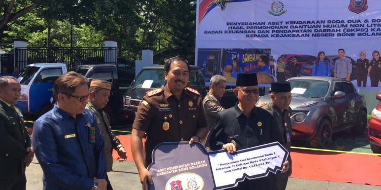 Bupati Ismet Mile didampingi Kajari Feddy Hantyo Nugroho pada penyerahan puluhan kendaraan dinas hasil permohonan bantuan hukum non litigasi dari Badan Keuangan dan Pendapatan Daerah (BKPD) kepada Kejaksaan Negeri Bone Bolango di halaman Kantor Kejaksaan Negeri Bone Bolango, Rabu (20/5/2026). (Foto Indra/Gopos)