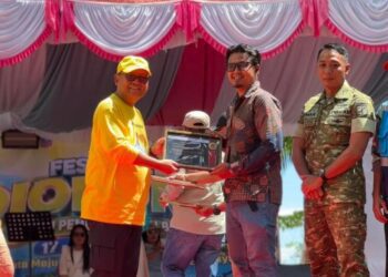 Pemberian piagam dari Bupati Gorontalo Utara Thariq Modanggu kepada PLN NP UP Gorontalo yang di wakili oleh TL SDM Umum dan CSR. (Foto.istimewa)